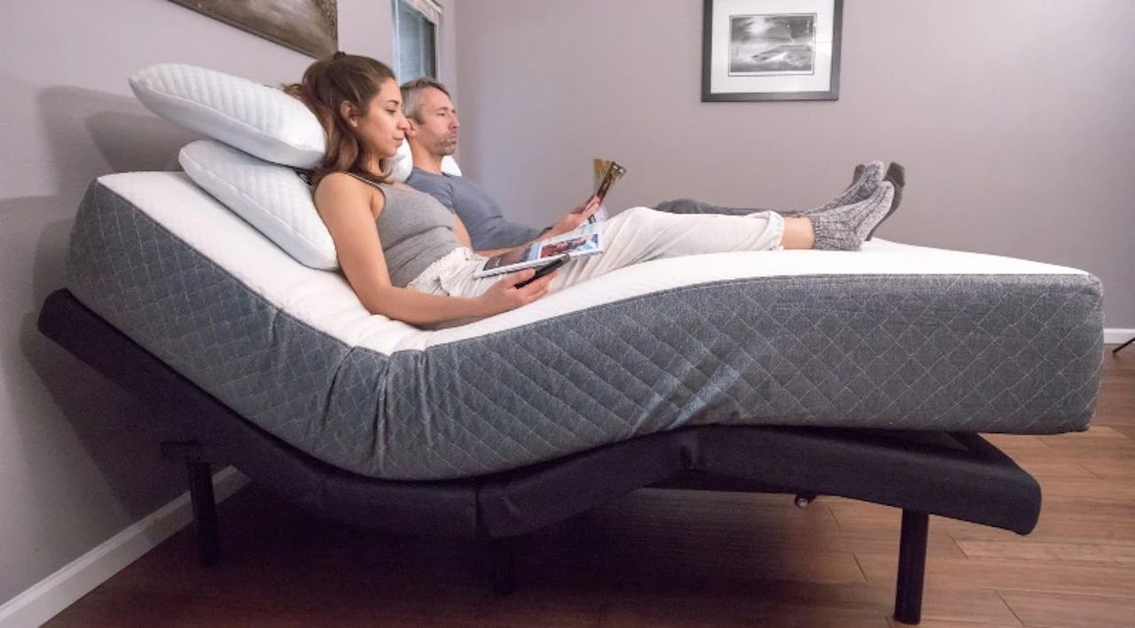 Couple relaxing in bed with head and legs elevated