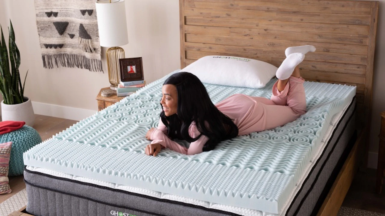 Woman laying on mattress topper with comfort and cooling features