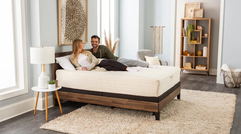 A couple relaxes on their king size GhostBed Natural mattress