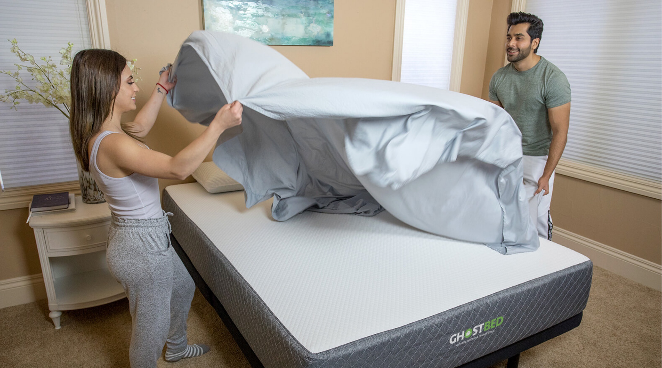 A couple makes their adjustable bed with deep-pocket sheets by GhostBed.