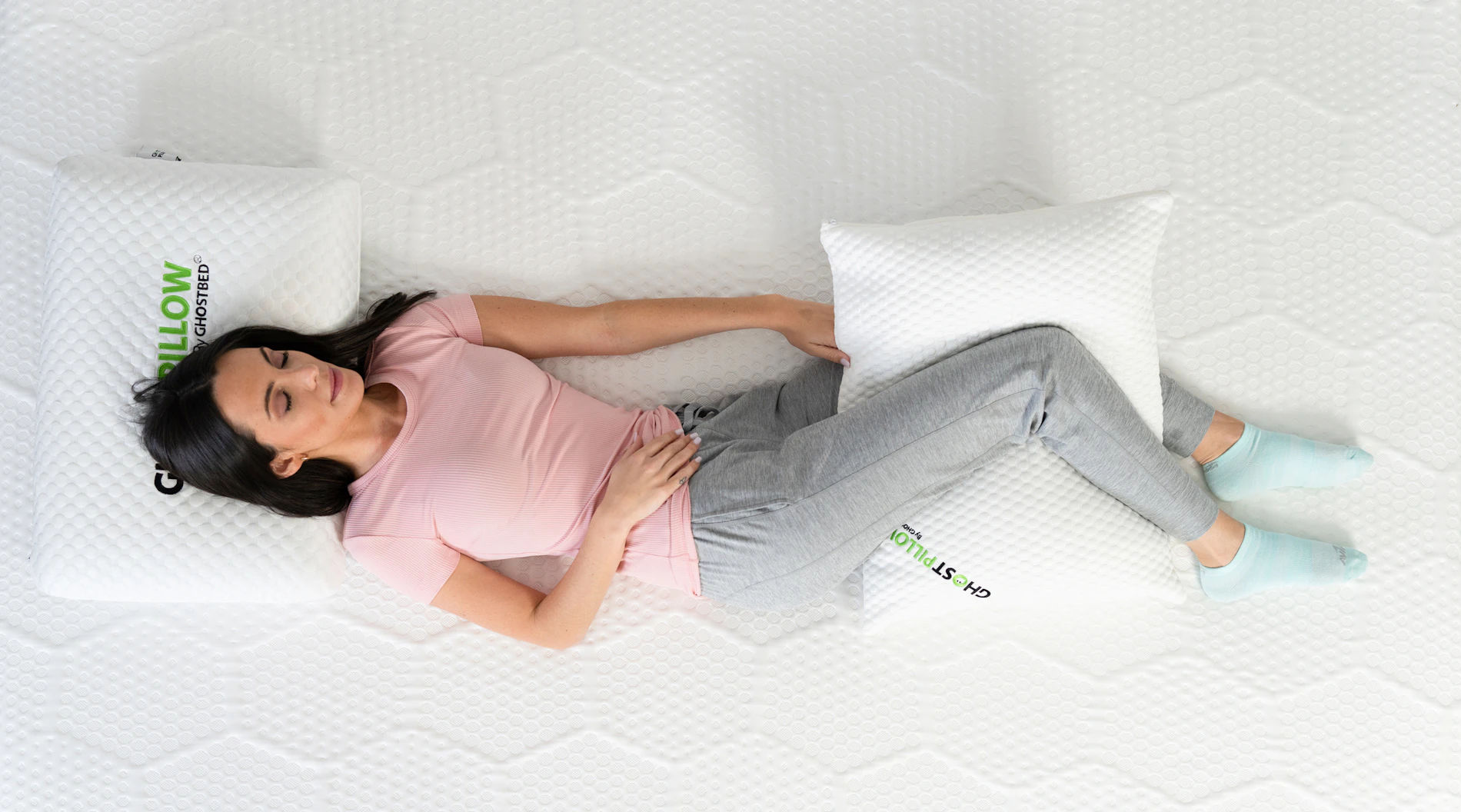 Woman lying on side on GhostBed mattress