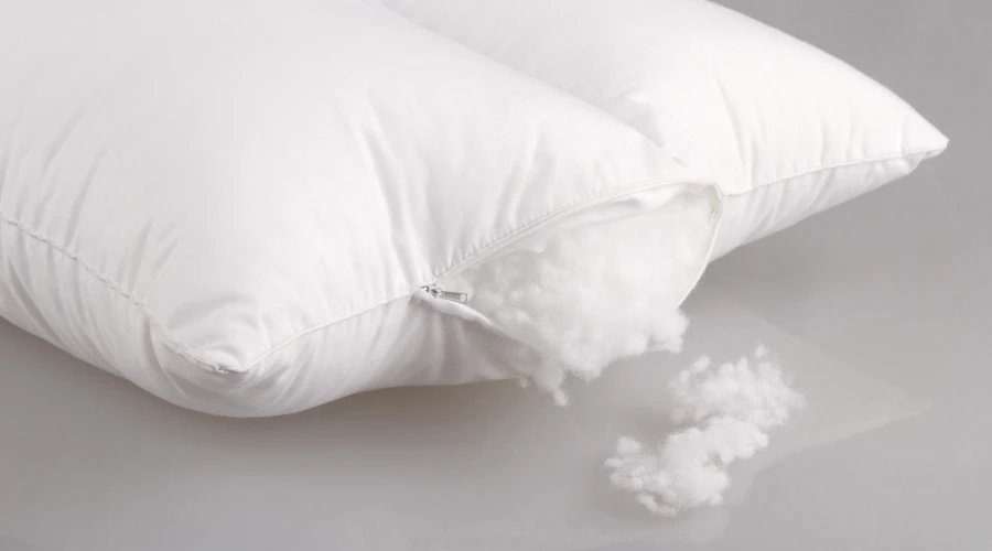 Pillow with wool filling spilling out.