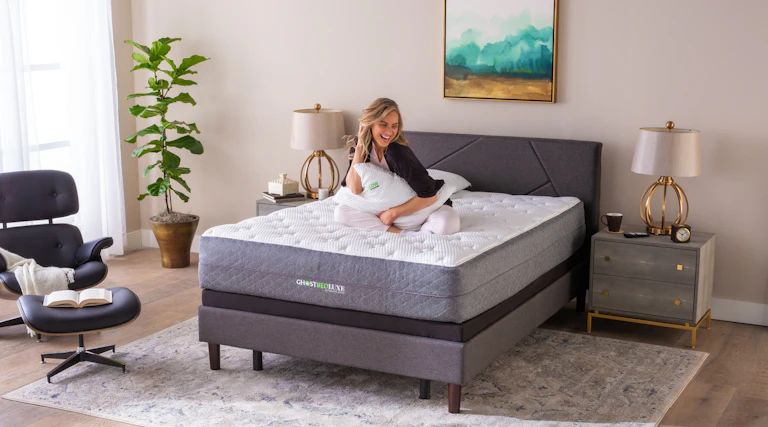 Woman sitting on queen size GhostBed Luxe