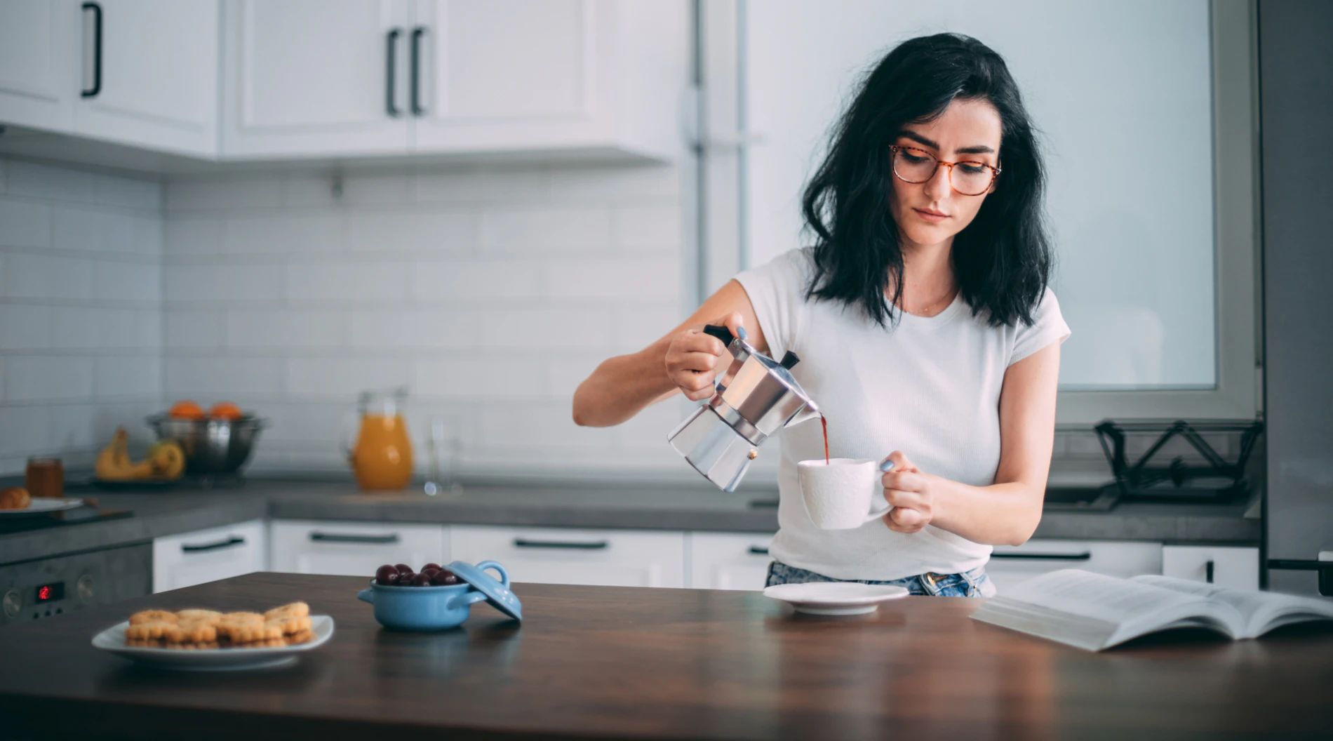 Woman pouring coffee in the morning.
