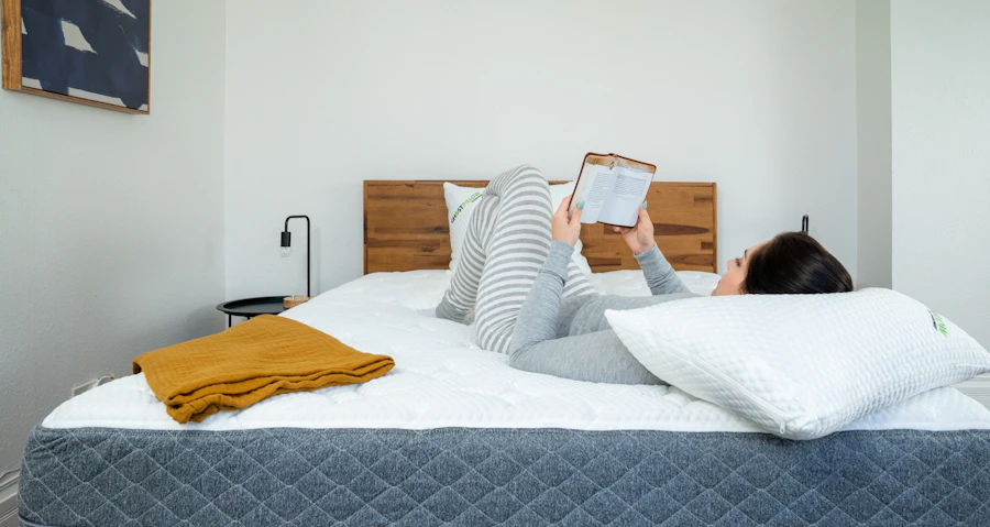 Young woman reads on her back on a GhostBed mattress
