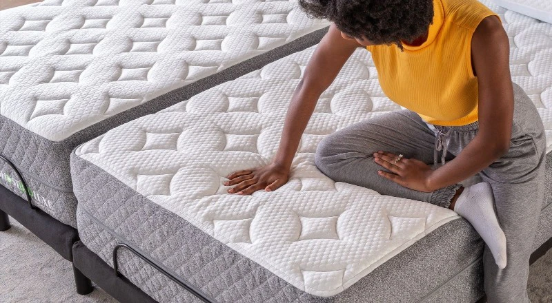 Woman pressing down on a clean memory foam mattress