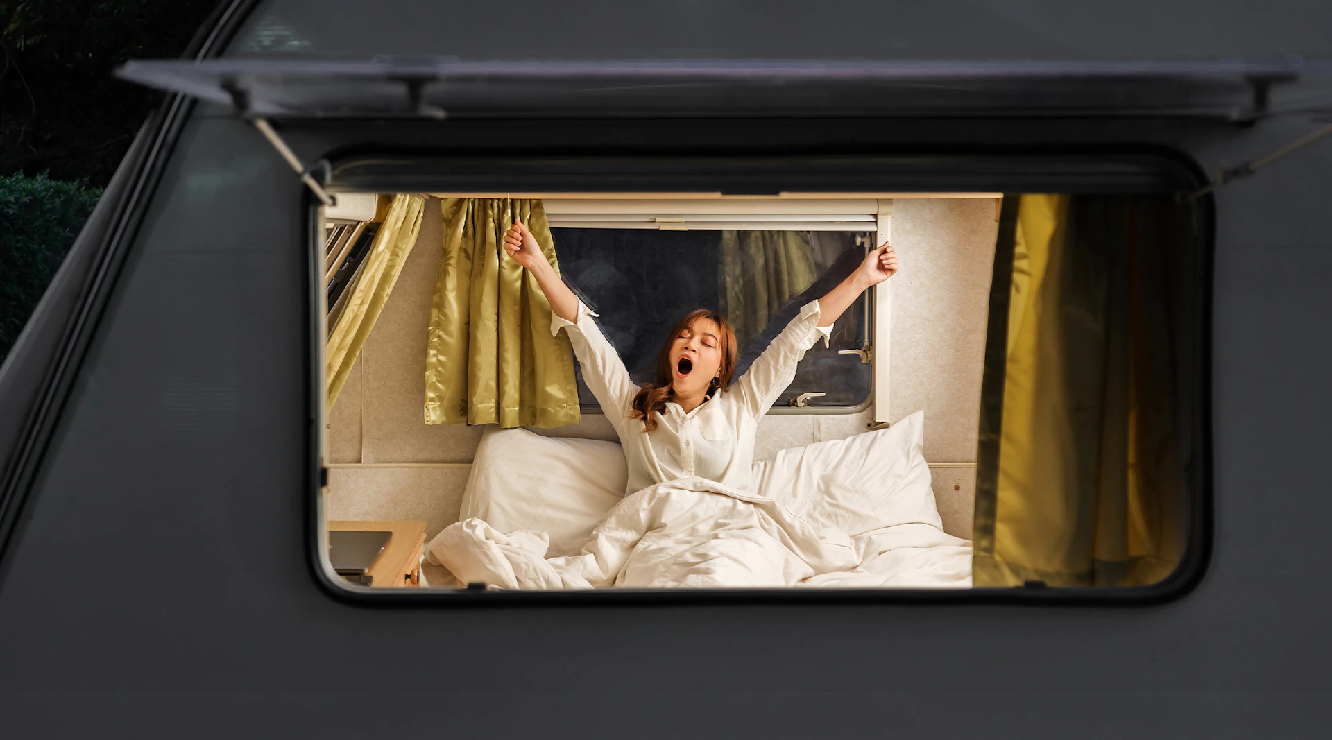 A woman gets ready for bed in her RV.