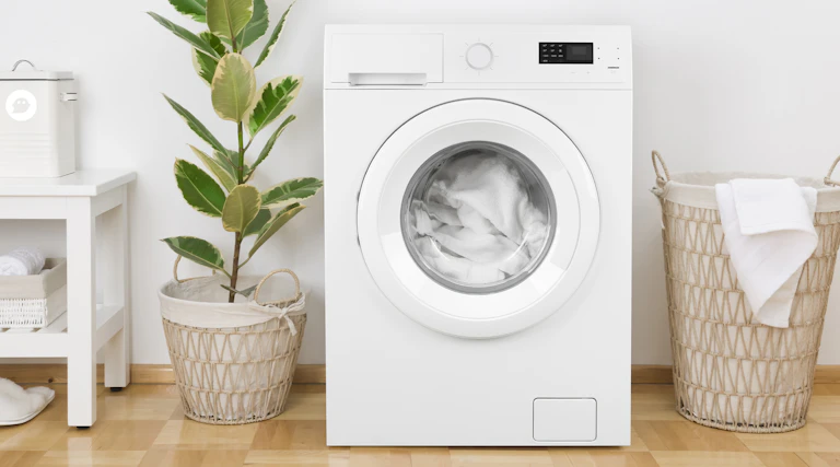 Washing machine with clean white bed sheets