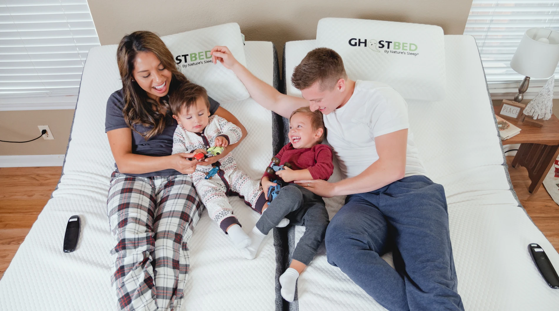 A family watches TV on their GhostBed Adjustable Base.