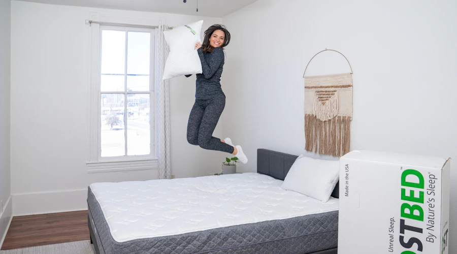 A woman jumps on her GhostBed mattress.