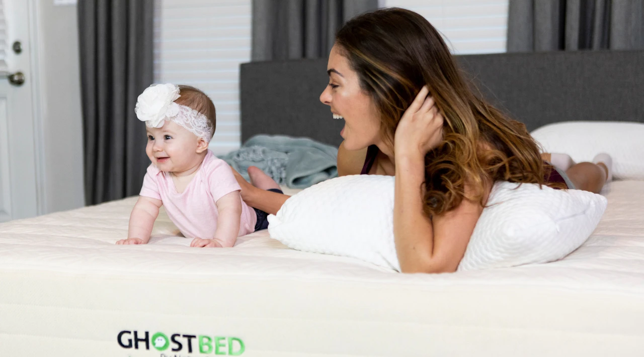 Une mère et son bébé jouent sur un matelas écologique GhostBed Natural.